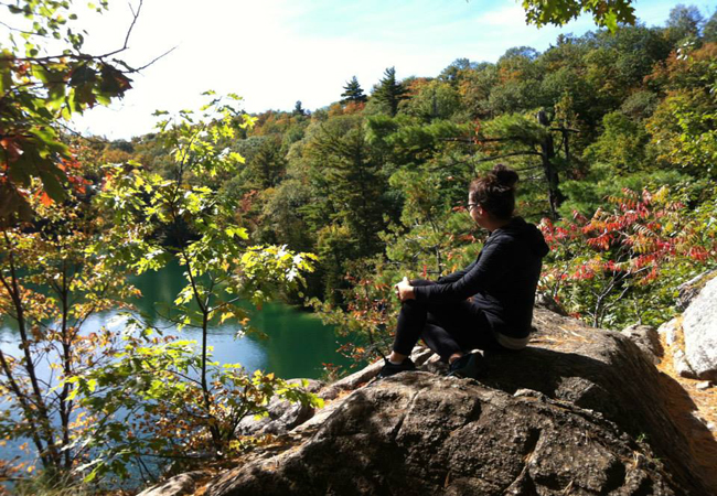 Jenn on a rock at Pink lake Gatineau Park
