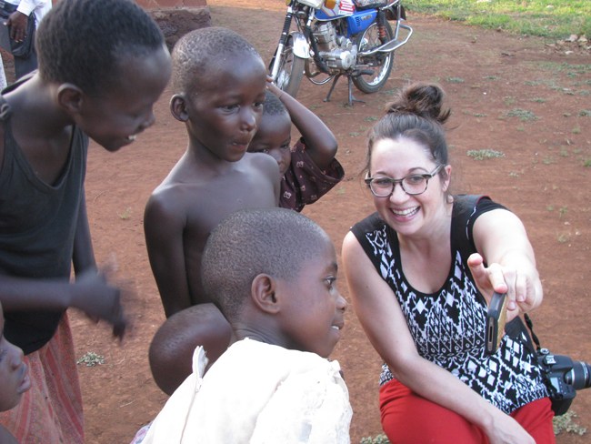 Jenn showing Ugandan kids their pictures